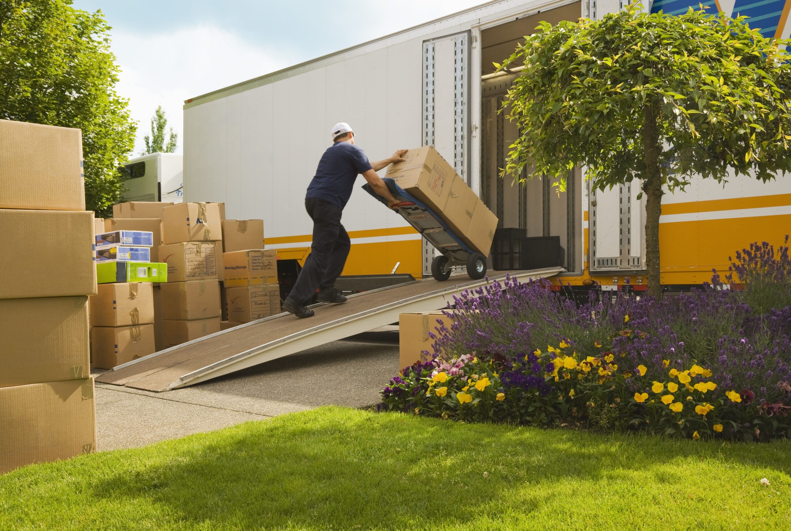 Professional movers carefully preparing belongings for relocation