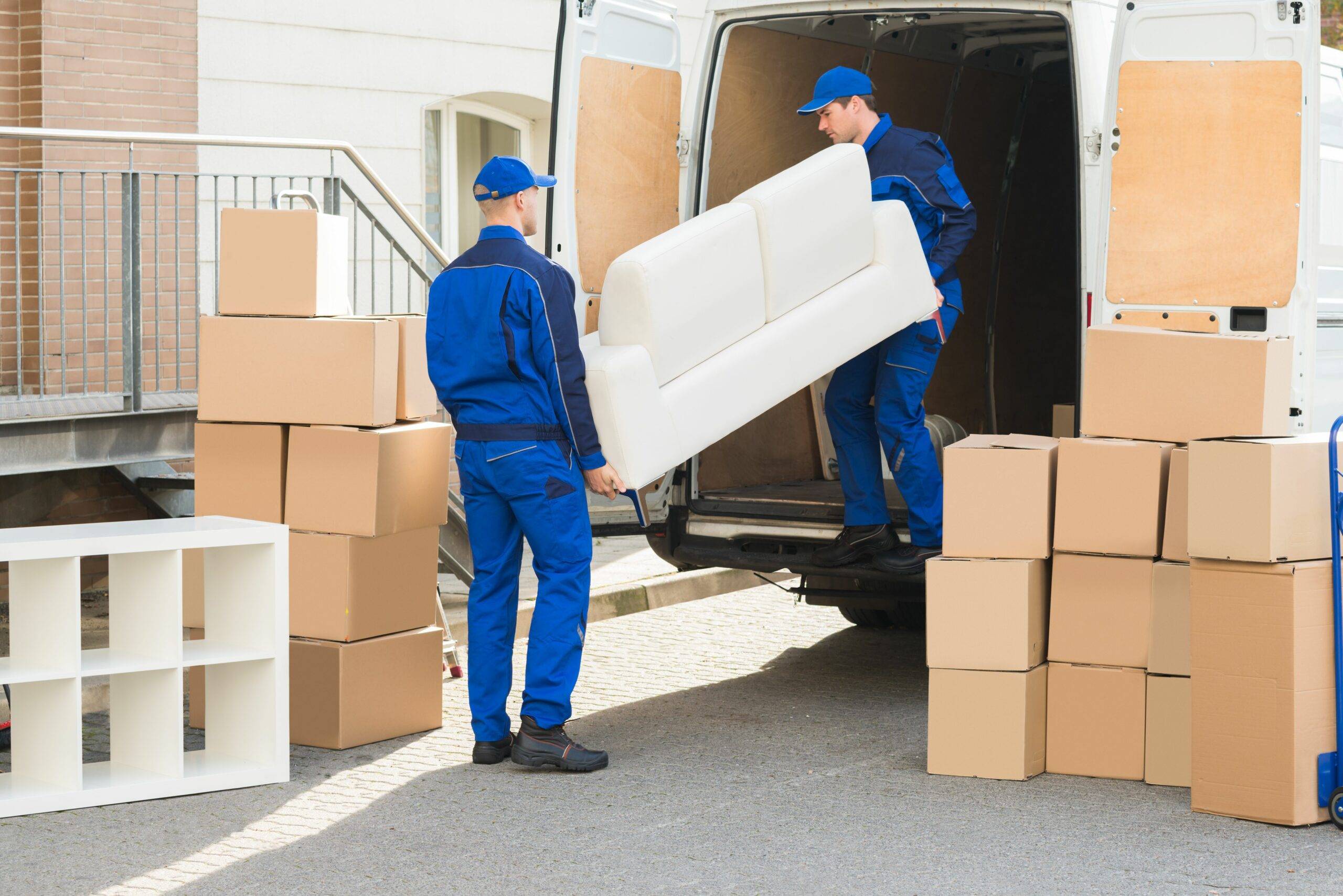 Professional moving team carefully handling household belongings